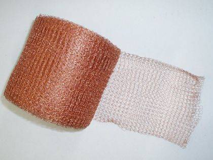 A roll of copper gas and liquid filter on the gray background.