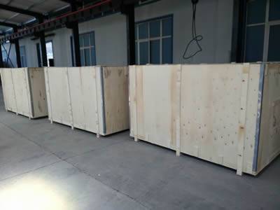 Three wooden boxes are placed in a workshop.
