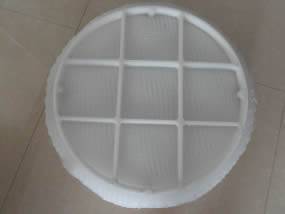 A round polypropylene demister pad with PP grid is on the floor and the grid is divided into 9 sections.