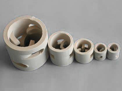 Five different sizes of ceramic pall ring on the gray background.