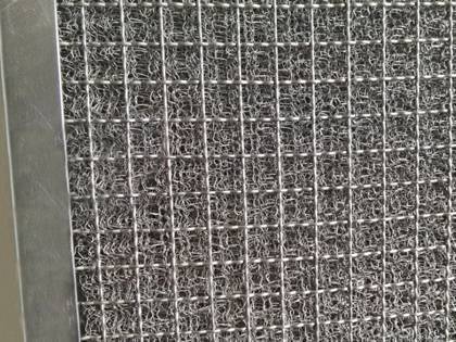 A stainless steel wire knitted mesh filter with crimped supporting grill.