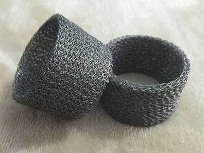 Two ring shape knitted wire mesh on the gray background.