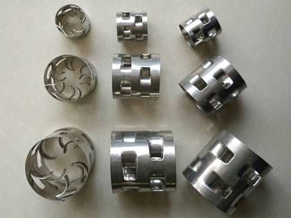 Nine metal pall rings on the gray background with different sizes.