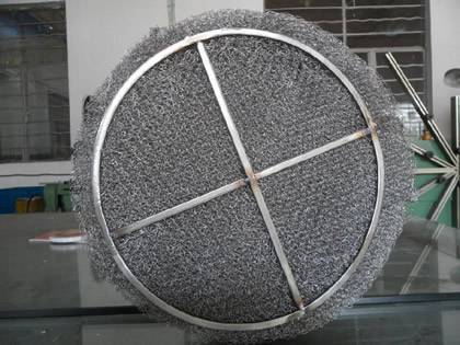A nickel wire demister pad is standing on the table.