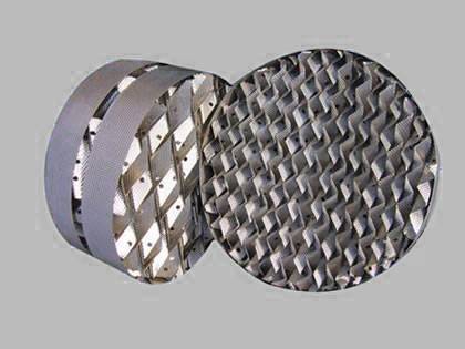 Two stainless steel structured packing on the gray background.