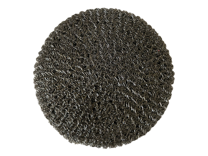 Circular spark arrestor pad on a white background