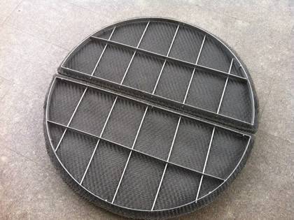 A round shape stainless steel demister pad on the ground.